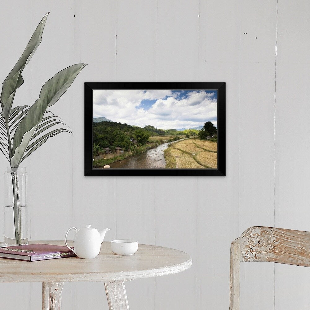 "A countryside river flowing through rice fields" Black Framed Print