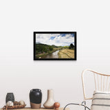 "A countryside river flowing through rice fields" Black Framed Print