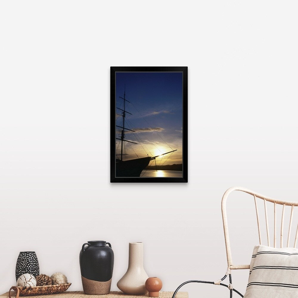 "A setting sun silhouettes an old sailing ship" Black Framed Print