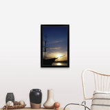 "A setting sun silhouettes an old sailing ship" Black Framed Print