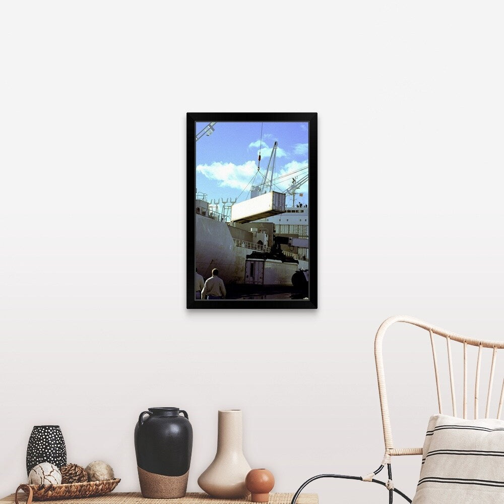 "Cranes carrying cargo containers at a port" Black Framed Print