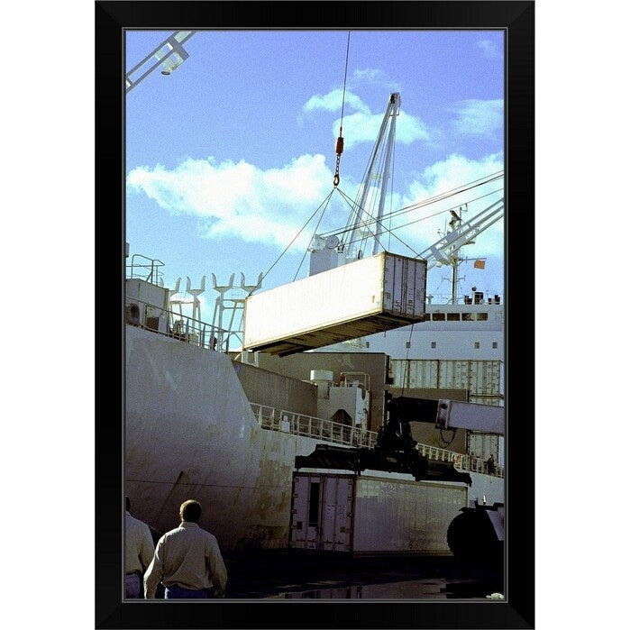 "Cranes carrying cargo containers at a port" Black Framed Print