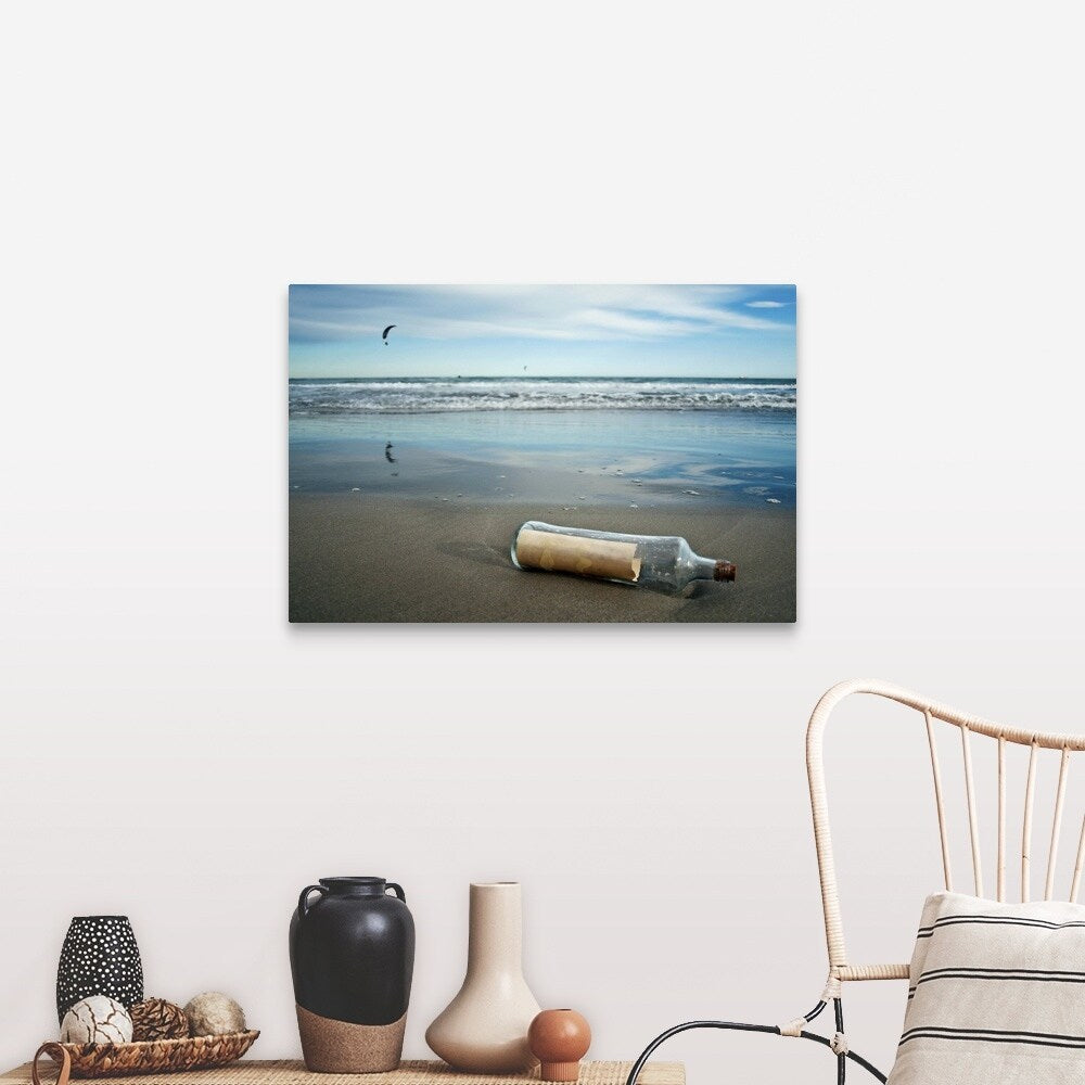 "Message in bottle on beach, with reflection on sand an blue sky in background." Canvas Wall Art
