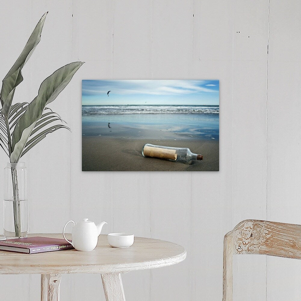 "Message in bottle on beach, with reflection on sand an blue sky in background." Canvas Wall Art