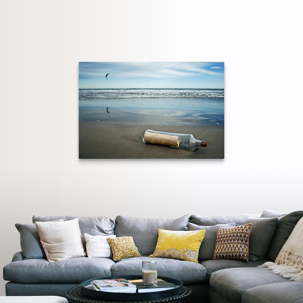 "Message in bottle on beach, with reflection on sand an blue sky in background." Canvas Wall Art