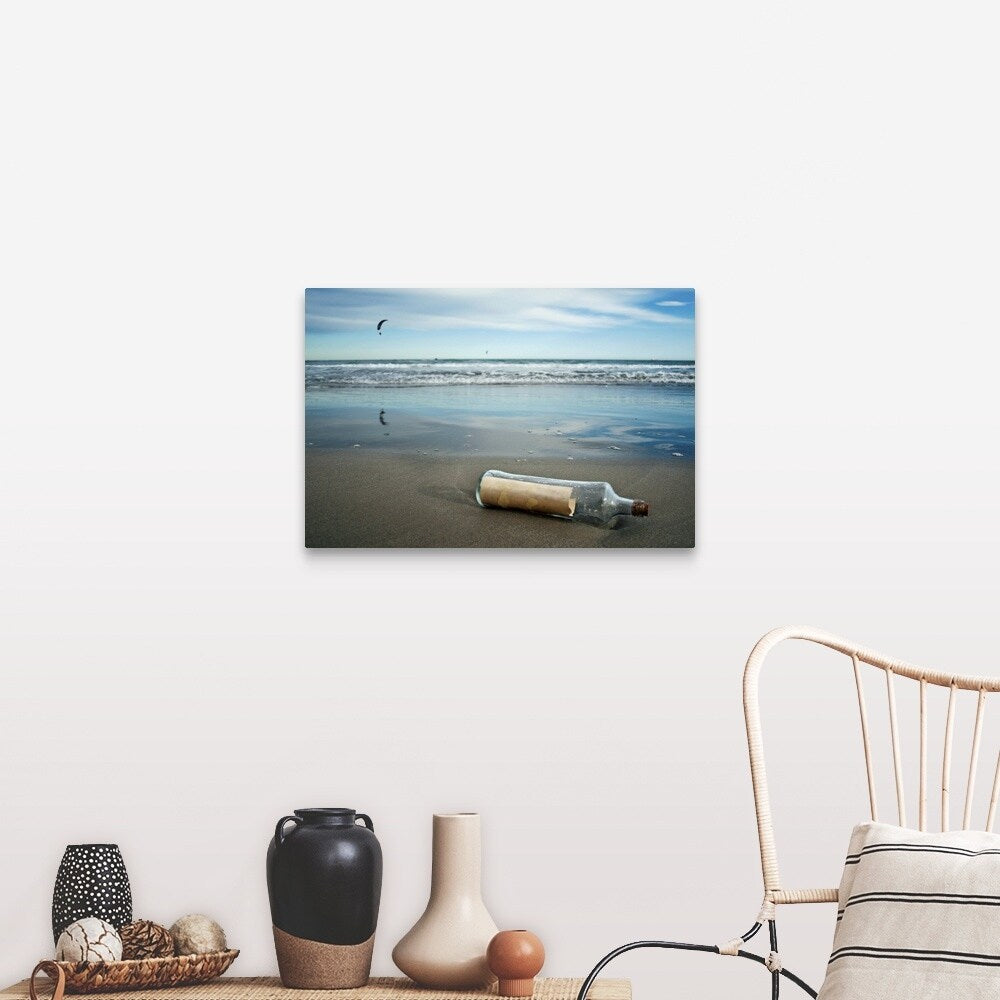 "Message in bottle on beach, with reflection on sand an blue sky in background." Canvas Wall Art