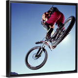 "Mountain biker riding over rocky terrain, view from below" Black Float Frame Canvas Art