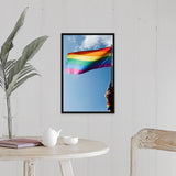 "Person's hand holding rainbow-colored flag waving in the sky" Black Float Frame Canvas Art