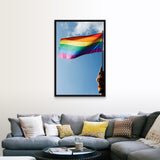 "Person's hand holding rainbow-colored flag waving in the sky" Black Float Frame Canvas Art