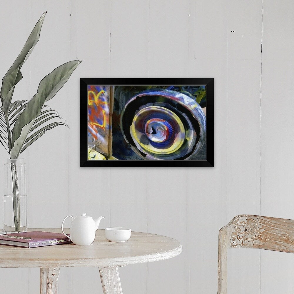 "Wheel of a half-buried Cadillac covered in graffiti, Cadillac Ranch Monument." Black Framed Print