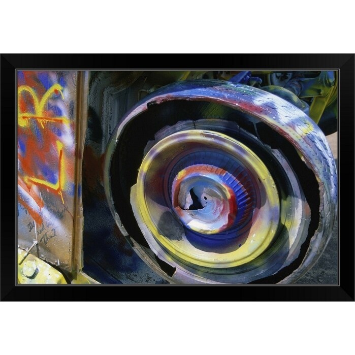 "Wheel of a half-buried Cadillac covered in graffiti, Cadillac Ranch Monument." Black Framed Print