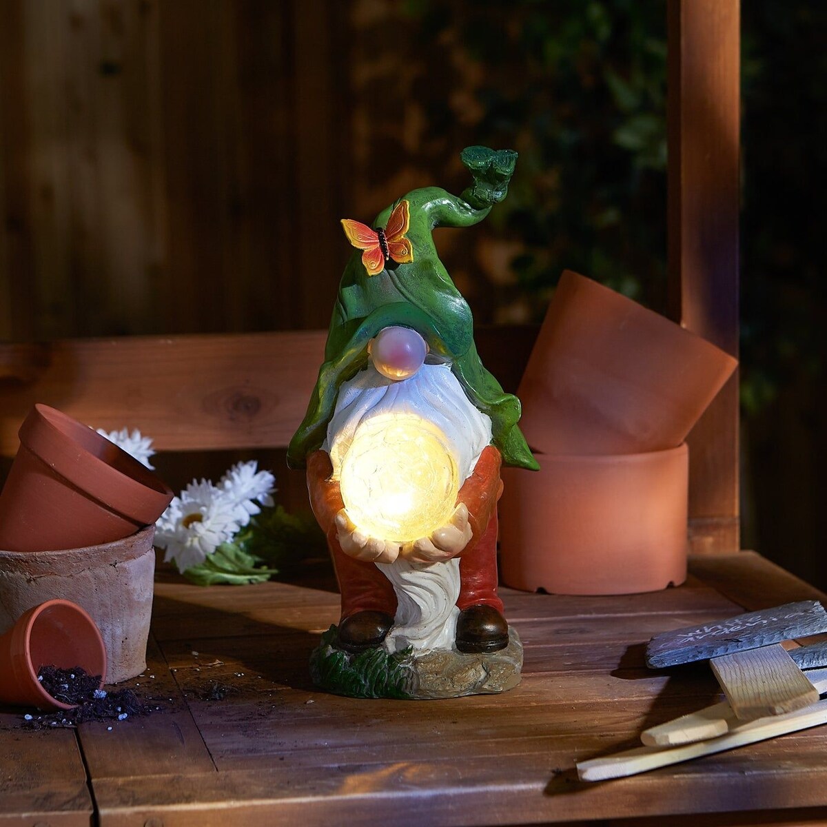 Gnome holding orb solar statue