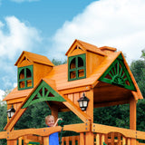 Gorilla Playsets Chateau Wood Swing Set with Malibu Roof, Rock Wall, and Built-In Picnic Table - Amber