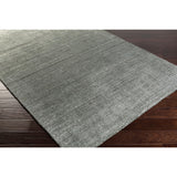 Hand-woven Dan Solid Viscose Area Rug