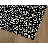 LEOPARD WHITE ON BLACK Area Rug by Marina Gutierrez
