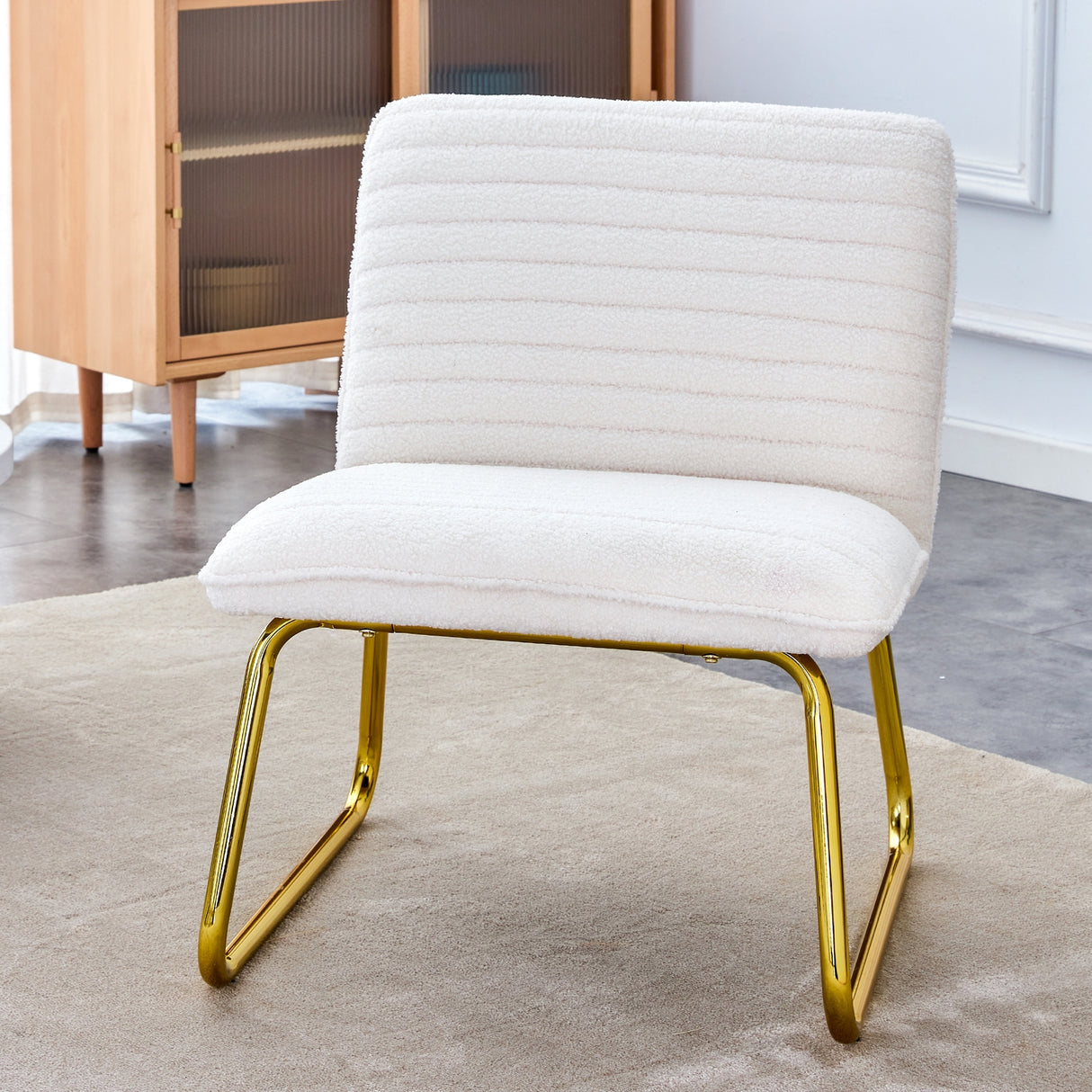 Minimalist armless chair with plush cushion and backrest with golden metal legs