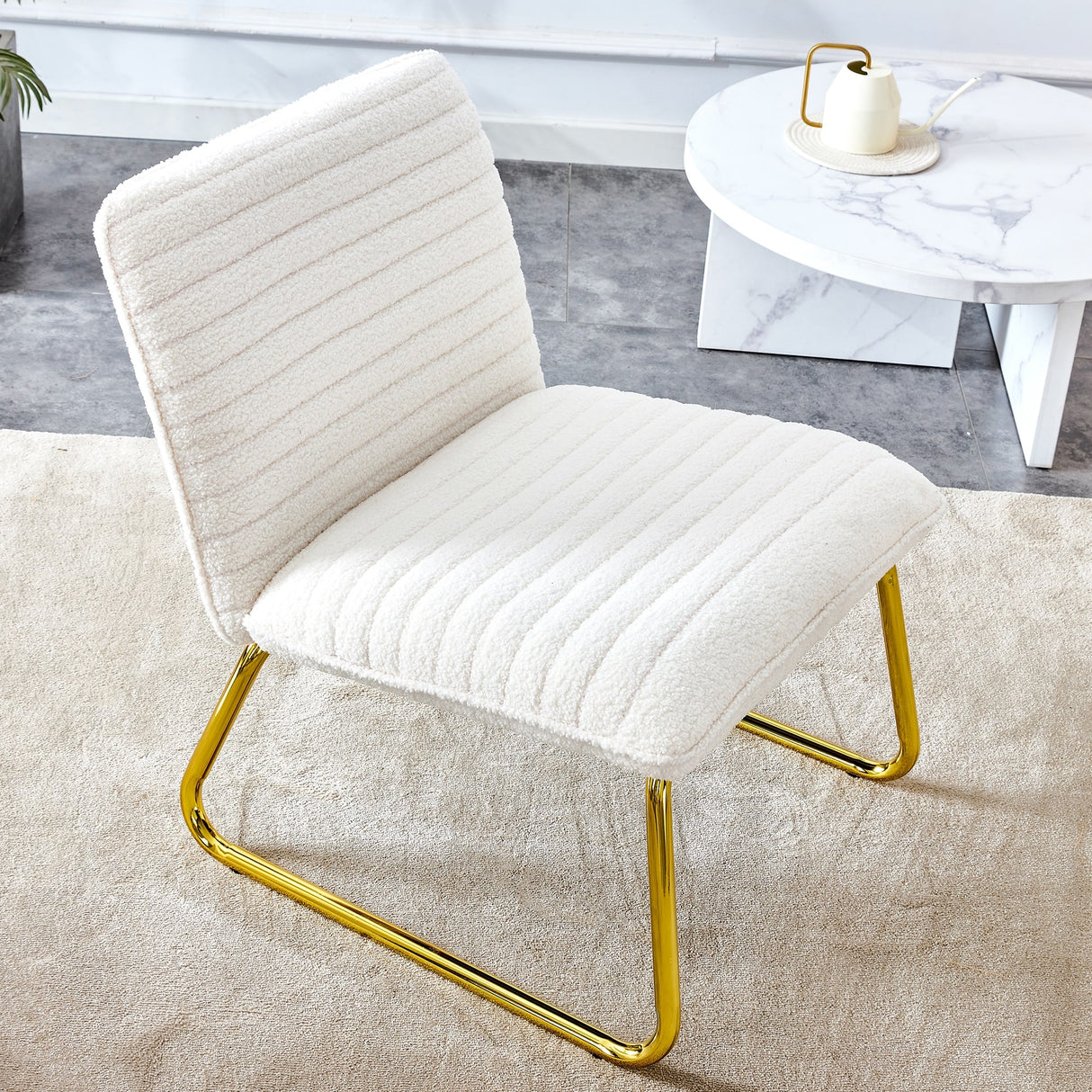 Minimalist armless chair with plush cushion and backrest with golden metal legs