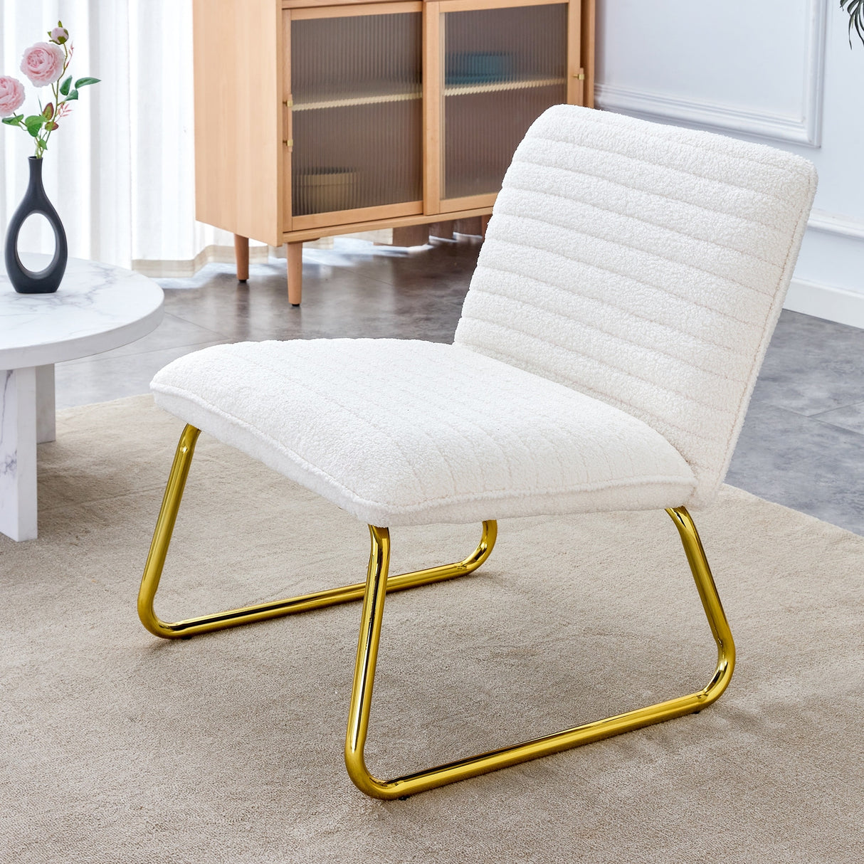 Minimalist armless chair with plush cushion and backrest with golden metal legs